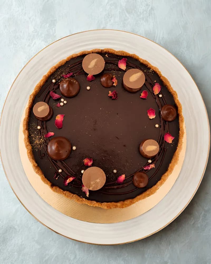 Chocolate ganache tart finished with rose petals