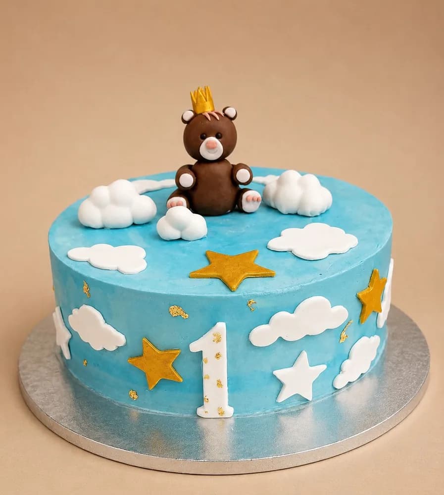 Teddy bear first birthday cake with clouds and stars